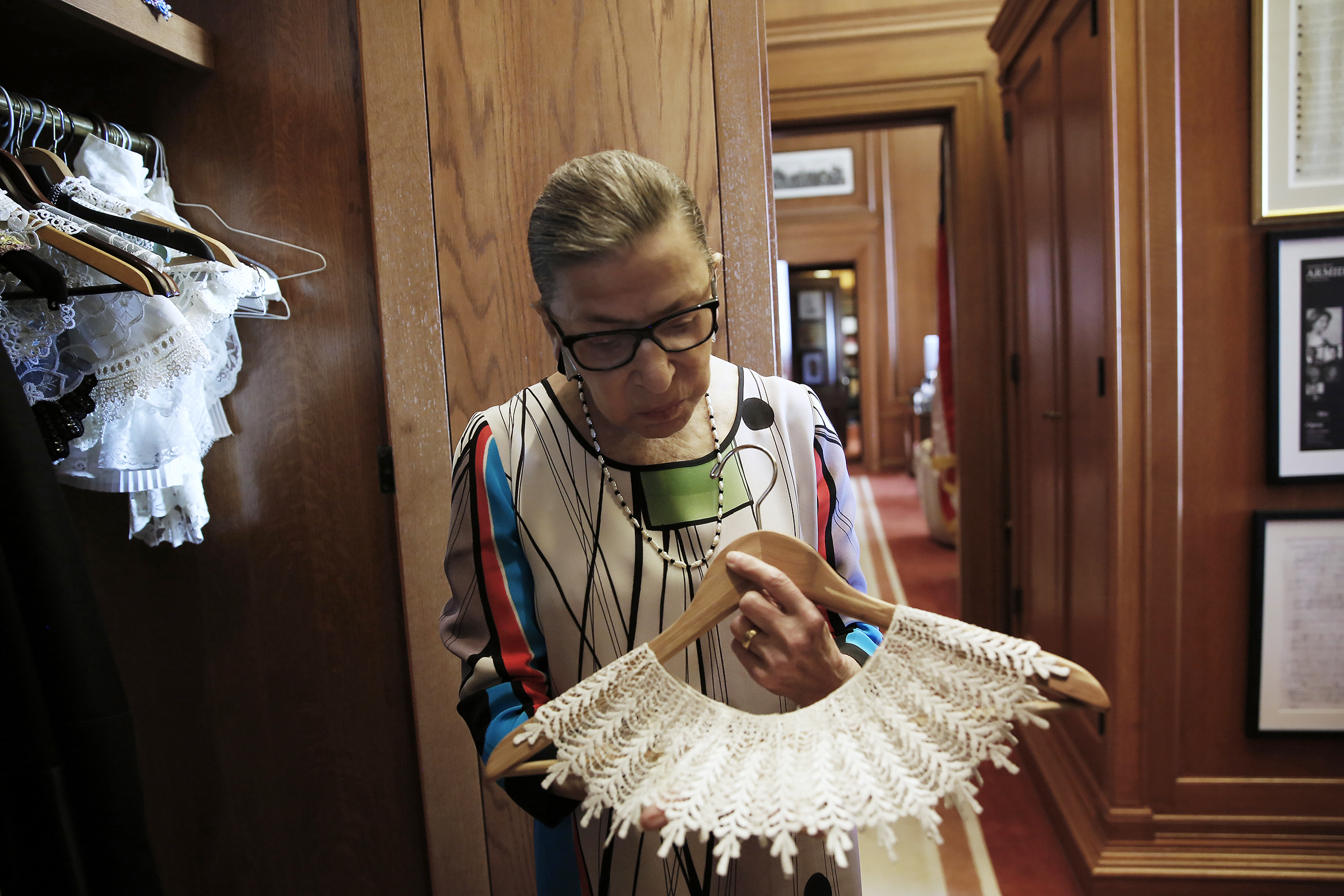U.S. Supreme Court Justice Ruth Bader Ginsburg shows the many different collars (jabots) she wears with her robes, in her chambers at the Supreme Court building in Washington, D.C., June 17, 2016. (REUTERS/Jonathan Ernst)